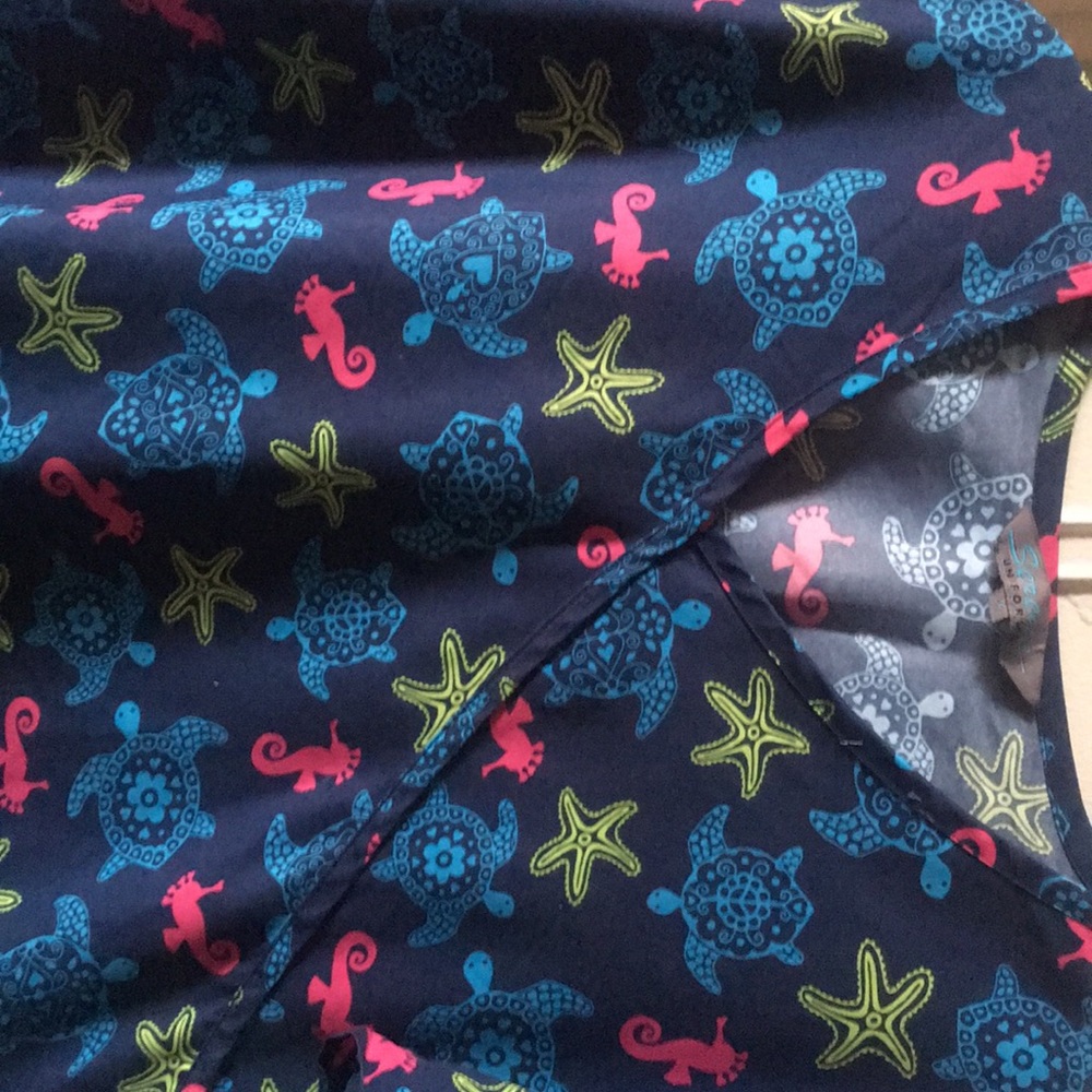 Mock tie under the seas scrub top